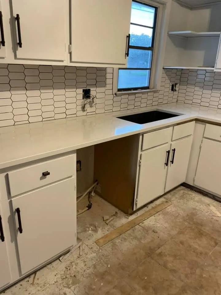 New countertop set on kitchen cabinets with the sink opening cut out